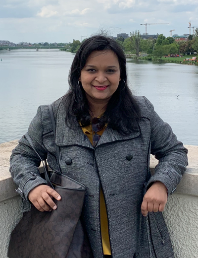 Anshika Jain standing in front of a river