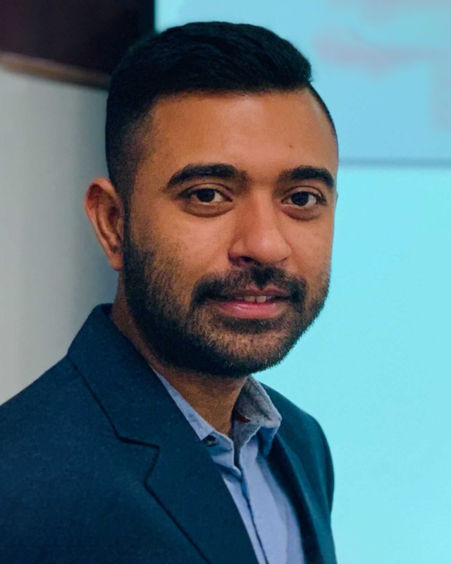 Suvo Chatterjee in front of a cyan background