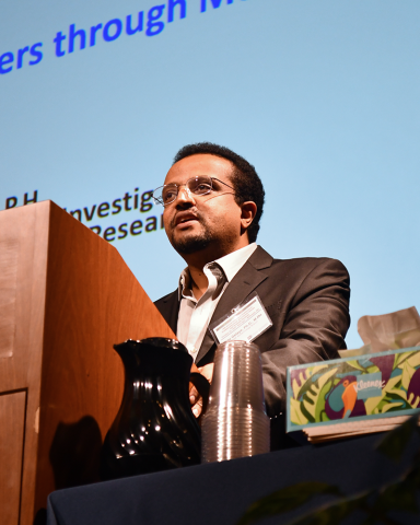 Dr. Bizu Galaye at the lectern for his keynote address